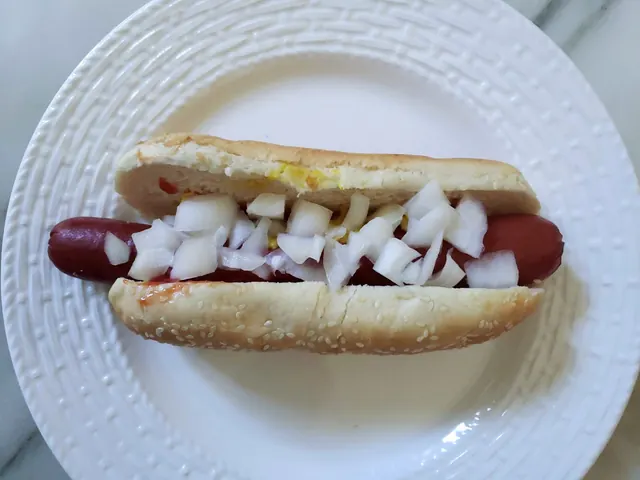 Costco hot dog topped with chopped onions